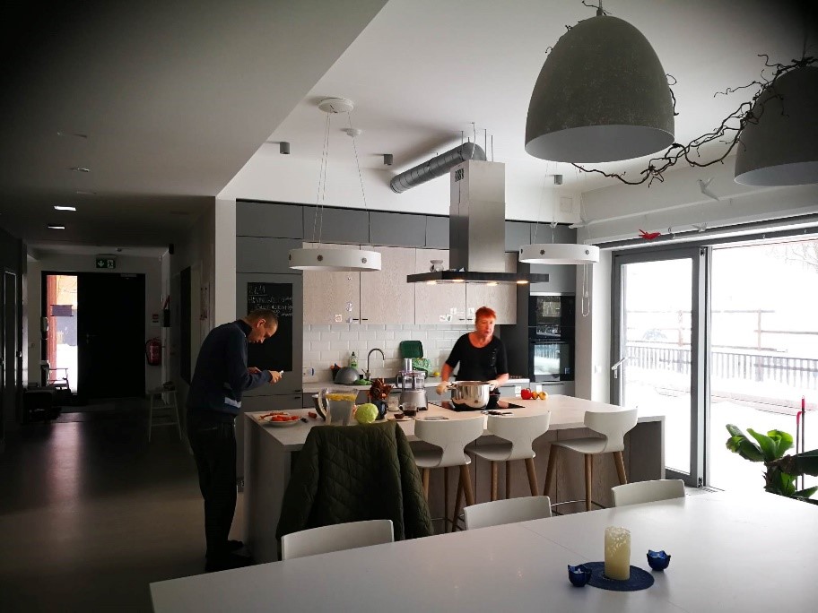 a couple of persons in a kitchen